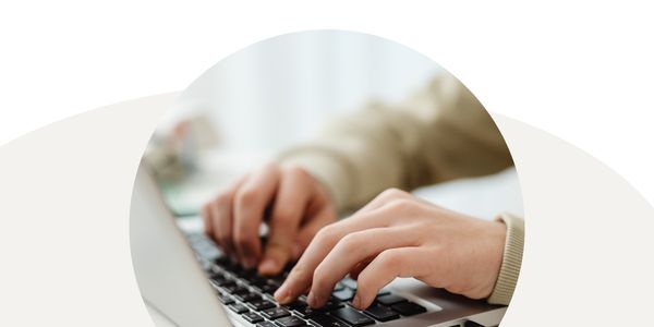 Graphic of hands typing on a laptop in a circular frame with a white and tan background.